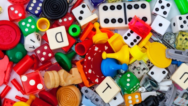 A jumble of various colourful board game tokens and dice.