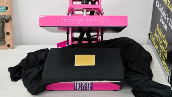 Printing a logo on a black t-shirt using Hoppip the Happy Press.