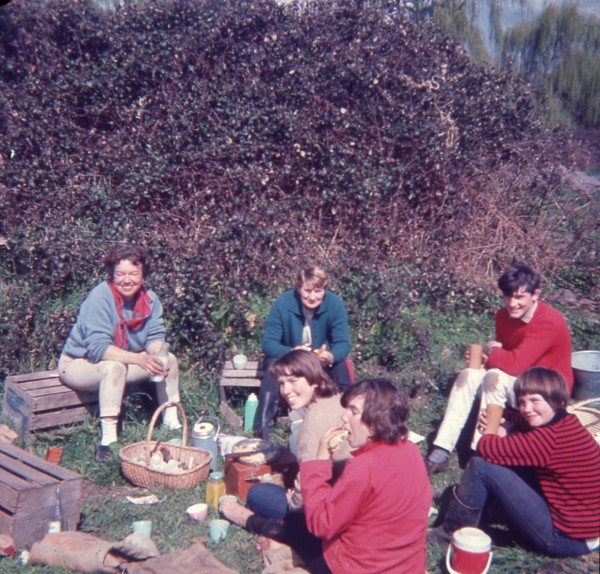 A colour image showing six people having a picnic.
