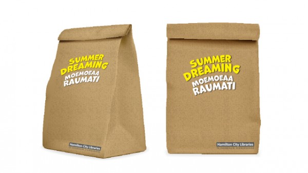 Two activity packs side by side in a brown paper bag.