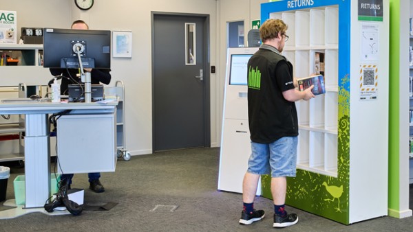 The front desk on the right side as you enter Hillcrest Library is height adjustable. The photo also shows returns shelves which can be reached by anyone.