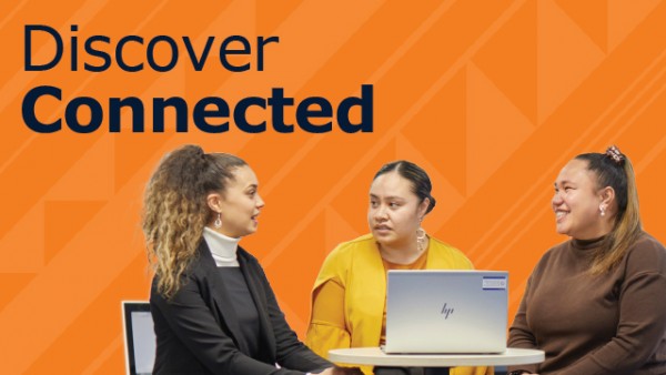 Three women sitting around a table with a laptop, talking. The background is orange with the words Discover Connected.