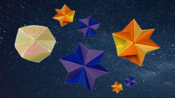 Purple and orange origami stars on a night sky background