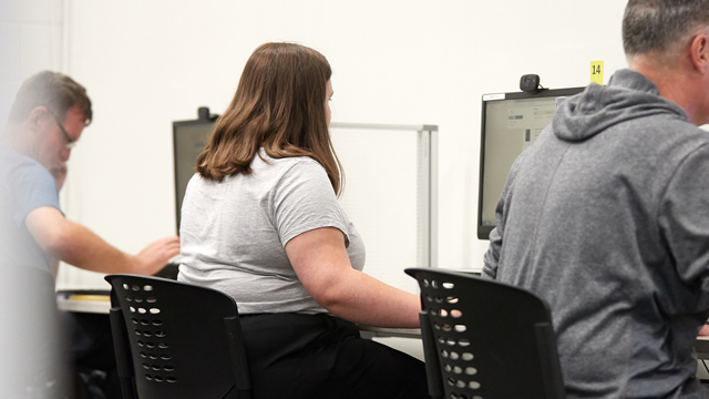 Men and woman working at computers