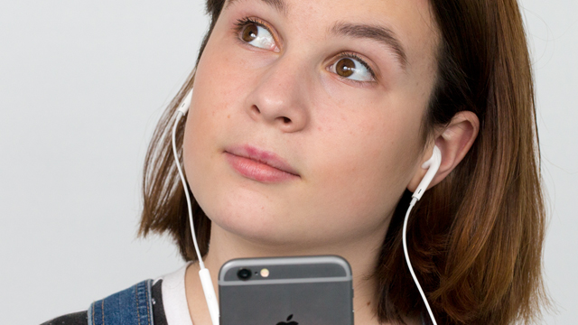 Girl with earphones listening to audio